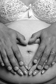 woman pregnant with partner hands in heart daniel james