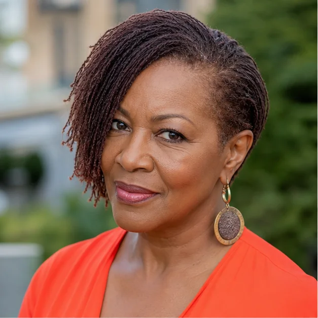 Black woman over 50 with an asymmetrical short Sisterlocks style