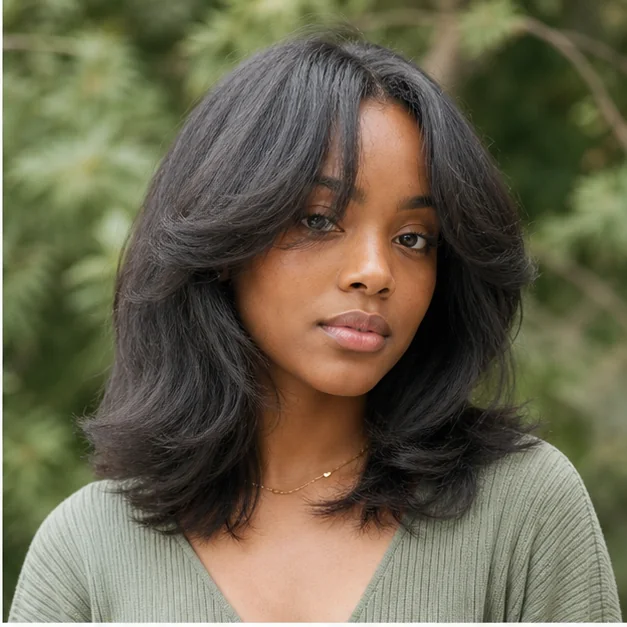Black woman with curtain bangs and a fluffy press