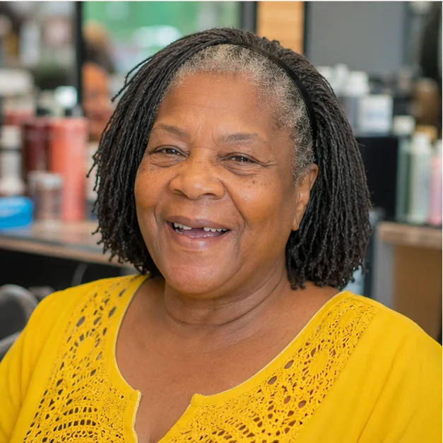 Black woman over 50 wearing a headband with naturally full Sisterlocks