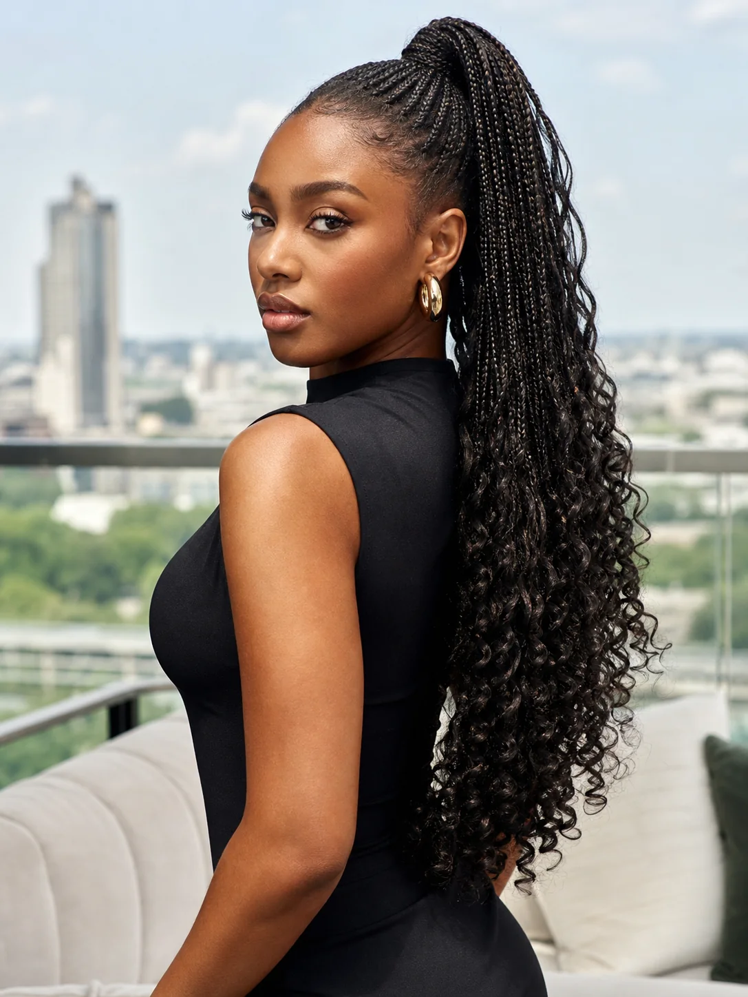 French curl braids in a high ponytail with cascading ends