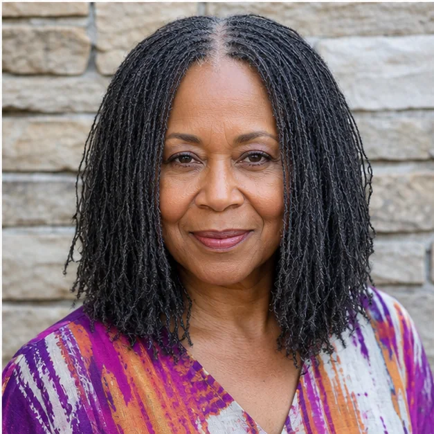 Black woman over 50 with loose Sisterlocks and a center part