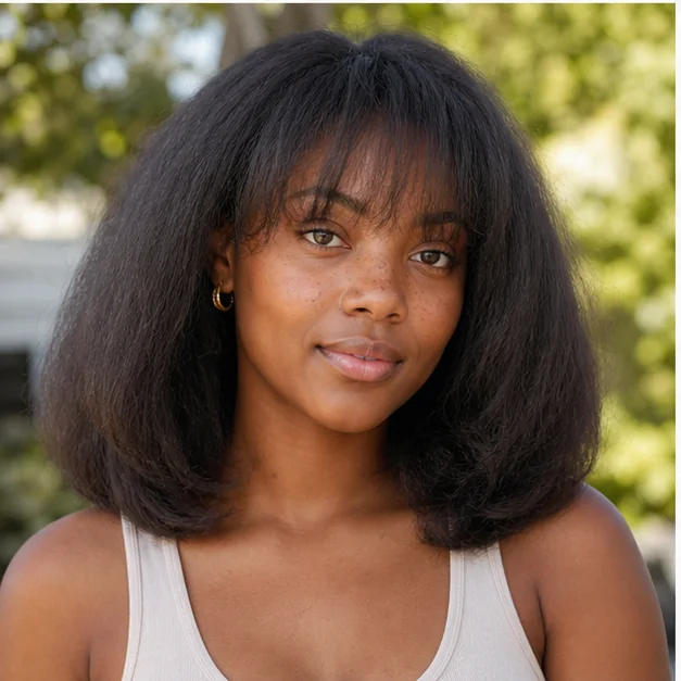Black woman with wispy bangs and a soft fluffy press
