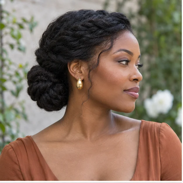 Black woman with an elegant twisted low natural-hair chignon