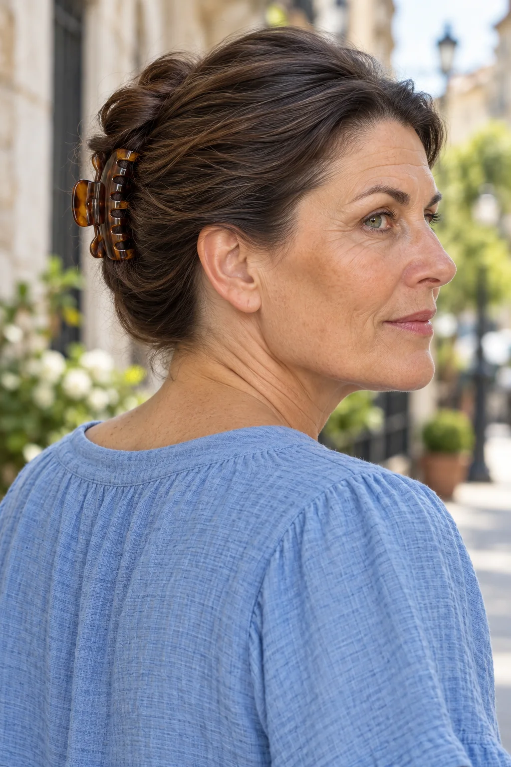 Shoulder-length brunette hair in a compact vertical folded twist held by a medium tortoiseshell claw clip