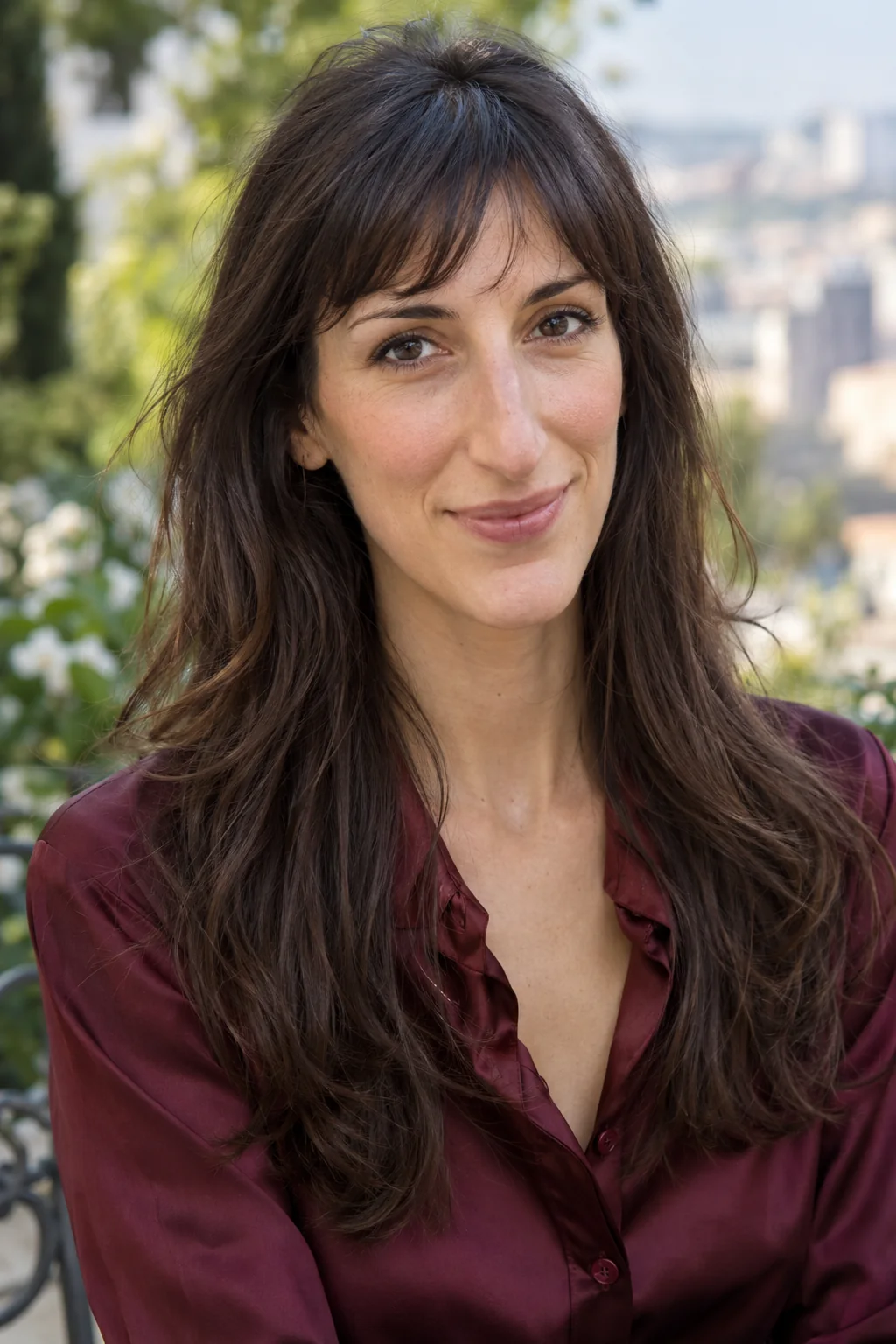 Dark brown long hair with a light curved fringe shorter centrally and gently longer at its outer corners